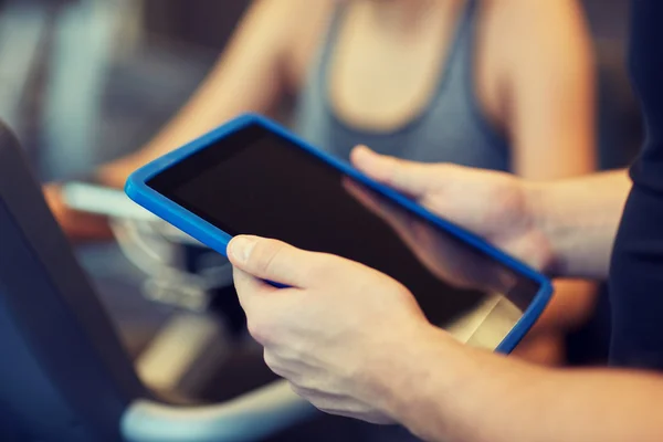 Close up of trainer hands with tablet pc in gym — Stock Photo, Image