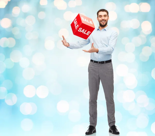 Smiling man with red shopping bag — Stock Photo, Image