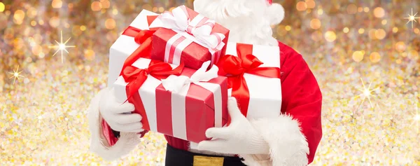 Человек в костюме Санта-Клауса с подарочными коробками — стоковое фото