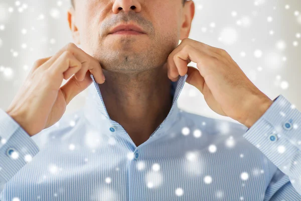 close up of man in shirt dressing