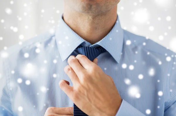 Close up of man in shirt adjusting tie on neck — Stock Photo, Image