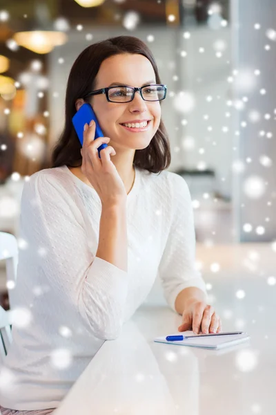 Mujer sonriente llamando en el teléfono inteligente en la cafetería —  Fotos de Stock