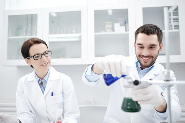 Young scientists making test or research in lab — Stock Photo, Image