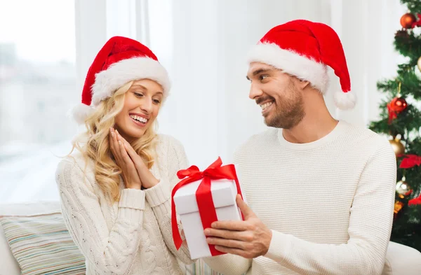 Feliz pareja en casa con caja de regalo de Navidad —  Fotos de Stock