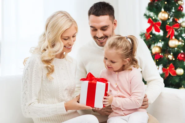 Famille heureuse à la maison avec boîte cadeau de Noël — Photo