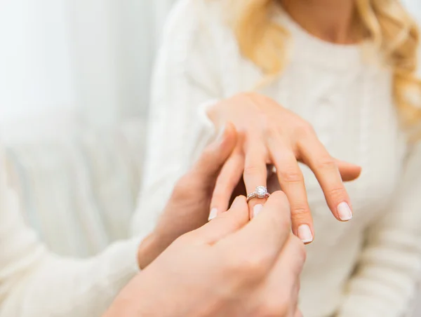Close up of man giving diamond ring to woman Royalty Free Stock Images