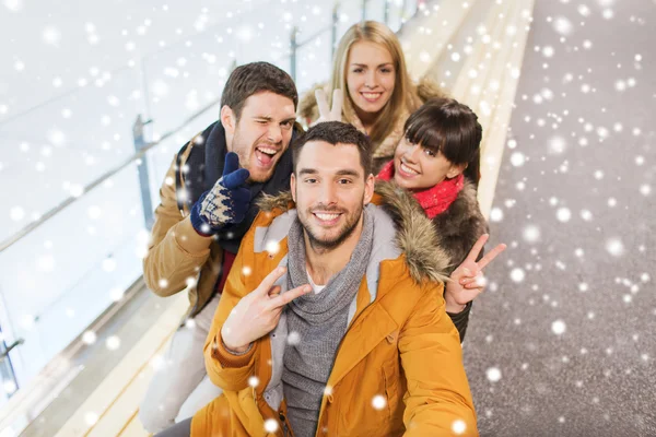 Happy friends taking selfie on skating rink — Stock Photo, Image