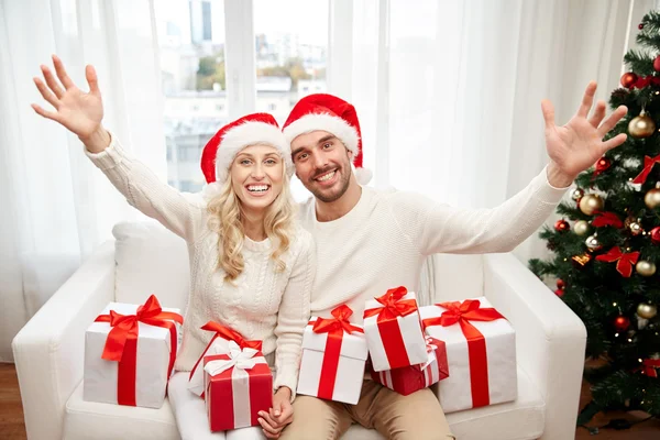 Casal feliz em casa com caixas de presente de Natal — Fotografia de Stock