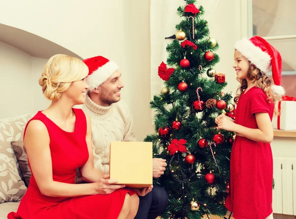 Lächelnde Familie schmückt Weihnachtsbaum — Stockfoto