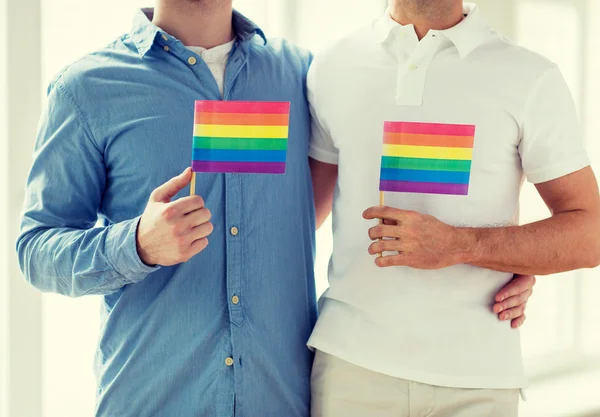 Close up de masculino gay casal segurando arco-íris bandeiras — Fotografia de Stock