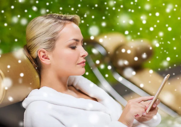 Beautiful young woman with smartphone at spa — Stock Photo, Image