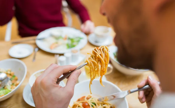 Close up man eating pasta for dinner at restaurant — Stok fotoğraf