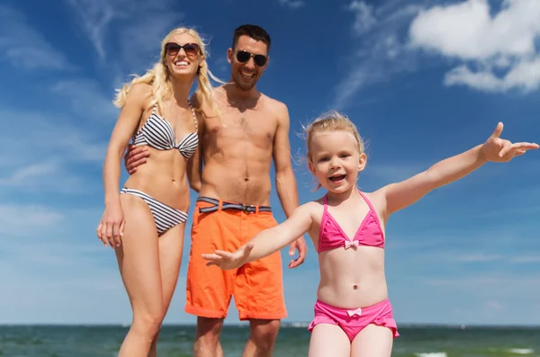 Close up of happy family with child on beach — Stok fotoğraf