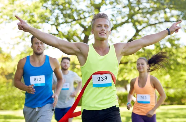 Happy young male runner winning on race finish — Stock Photo, Image