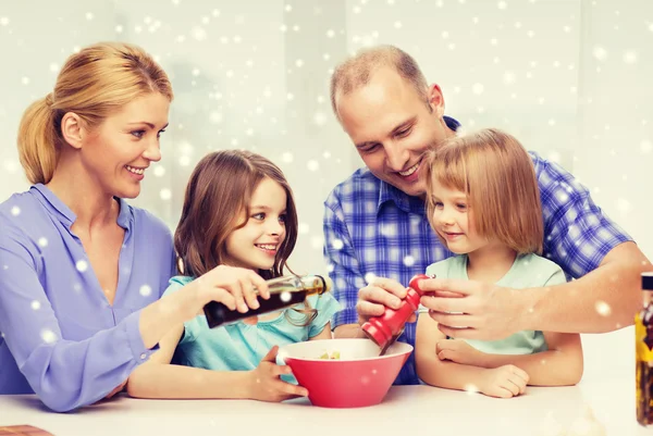 Happy family with two kids making salad at home — Stock Photo, Image