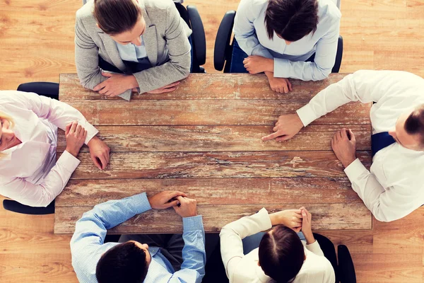 Close up of business team sitting at table — Stock Photo, Image