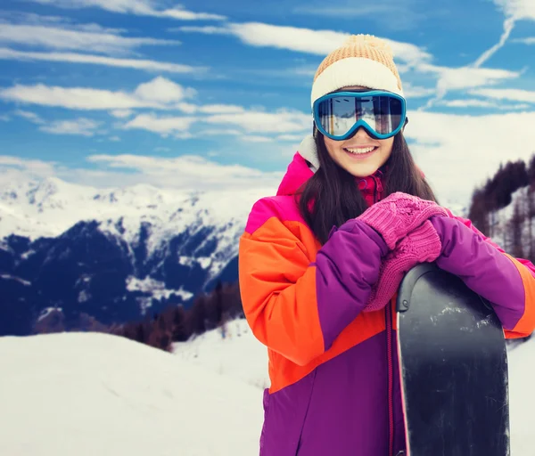 Happy young woman with snowboard over mountains — Stock Photo, Image