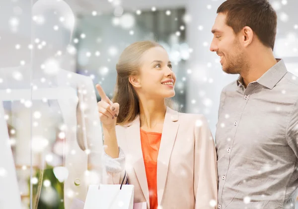 Feliz pareja joven con bolsas de compras en el centro comercial —  Fotos de Stock