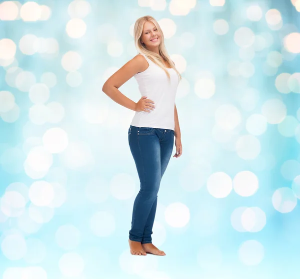 Smiling young woman in blank white shirt and jeans — Stok fotoğraf