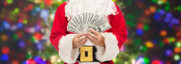 Primer plano de santa claus con dinero en dólares —  Fotos de Stock