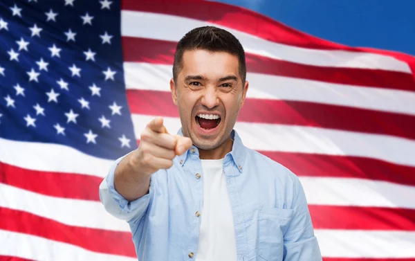 Angry man pointing on you over american flag — Stok fotoğraf