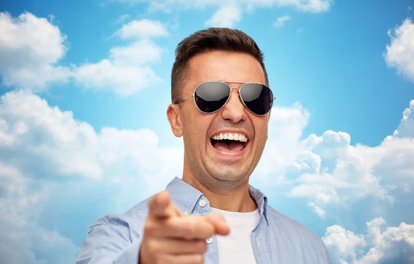 Lachender Mann mit Sonnenbrille zeigt mit dem Finger auf dich — Stockfoto