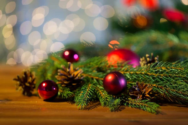 Fir branch with christmas ball and pinecones — Stock Photo, Image