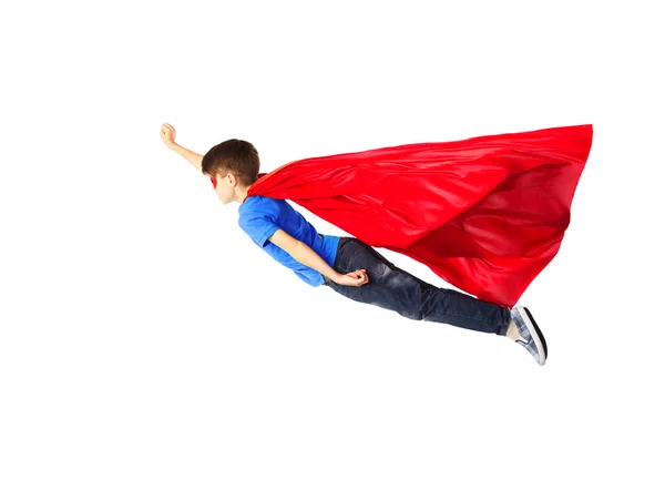 Boy in red superhero cape and mask flying on air — Stock Photo, Image