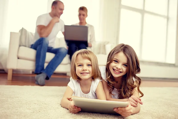 Happy little girls with tablet pc computer at home — Stock Photo, Image