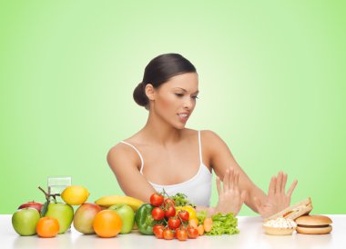 woman with fruits rejecting hamburger clipart