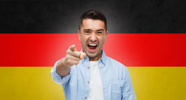 Wütender Mann zeigt mit Finger auf Deutschland-Fahne — Stockfoto