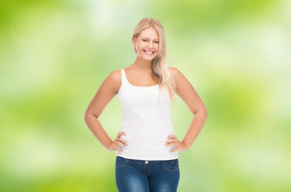 Smiling young woman in blank white shirt and jeans — Stockfoto
