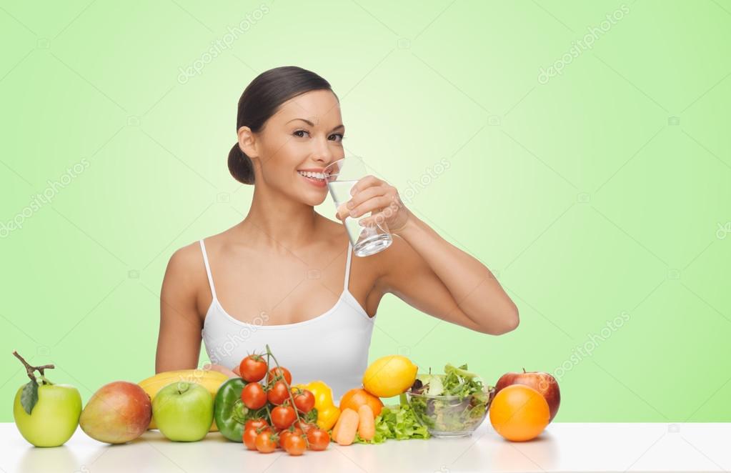 Woman with fruits and vegetables drinking water — Stock Photo © Syda_Productions 89382236