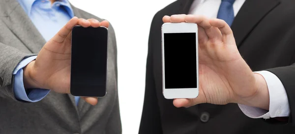 Businessman and businesswoman with smartphones — Stock Photo, Image