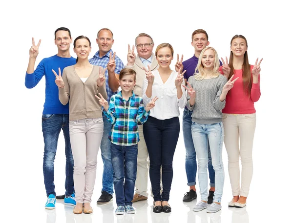 Group of smiling people showing peace hand sign — Stok fotoğraf