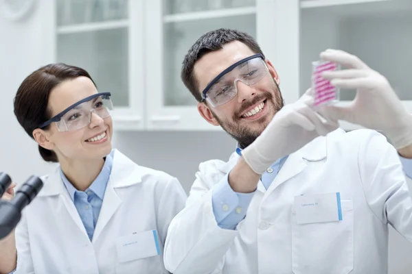 Young scientists making test or research in lab — Stock Photo, Image