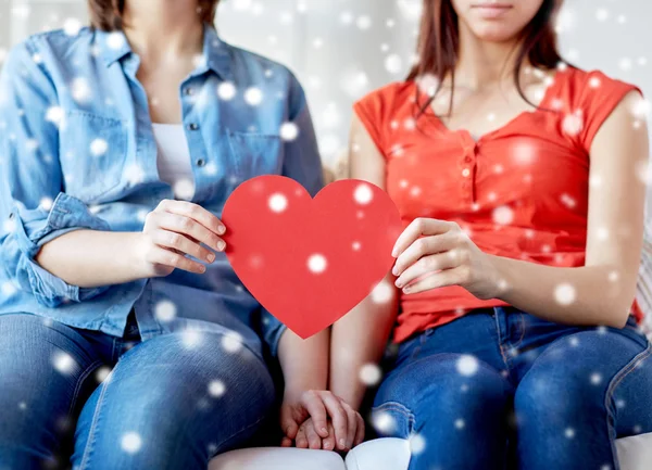 Close up of happy lesbian couple with red hearts — Stock Photo, Image