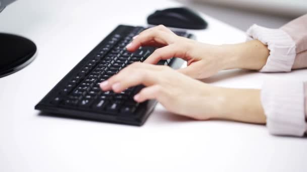 Woman hands typing on computer keyboard at office — Stock Video