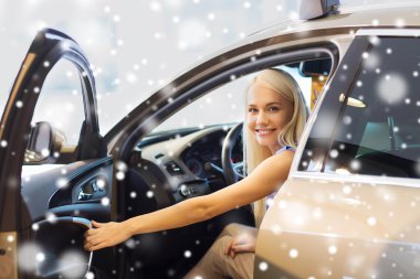 happy woman inside car in auto show or salon clipart