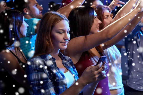 Woman with smartphone texting message at concert — Stock Photo, Image