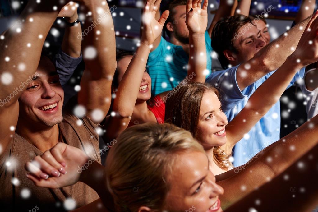 party, technology, nightlife and people concept - smiling friends with  smartphone taking selfie in club. Stock Photo