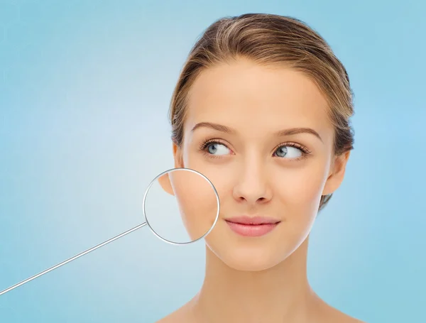 Young woman face with magnifier showing good skin — Stock Fotó