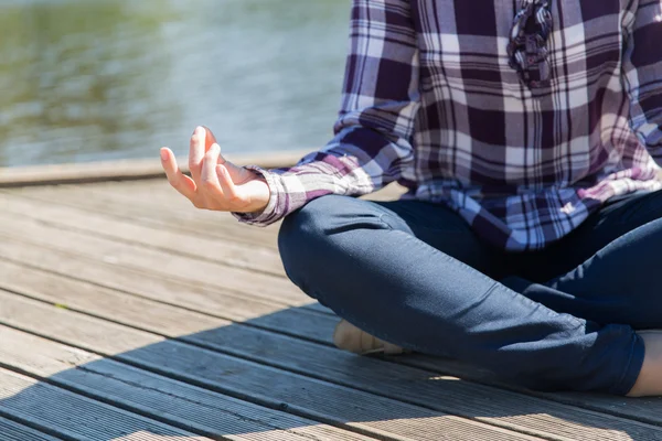 Close up of woman in yoga lotus pose outdoors — Stockfoto