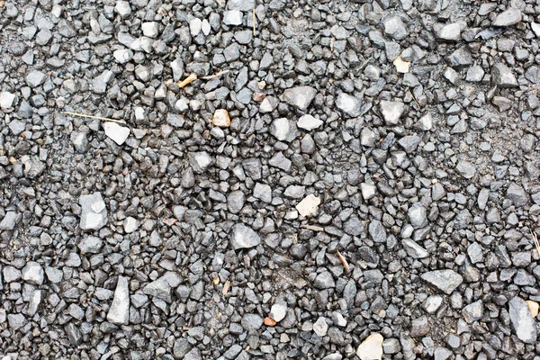 Primer plano de piedras grises macadam en el suelo — Foto de Stock