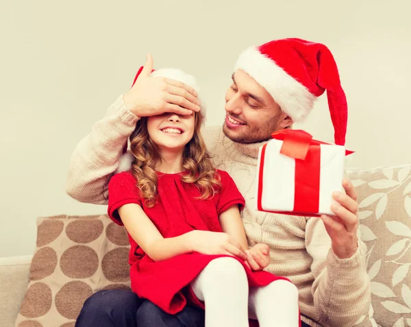 Smiling father surprises daughter with gift box — Stock Photo, Image