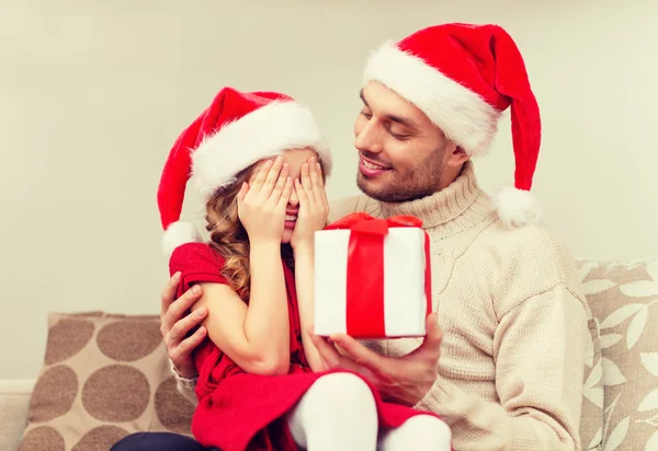 Smiling daughter waiting for a present from father — Stock Photo, Image