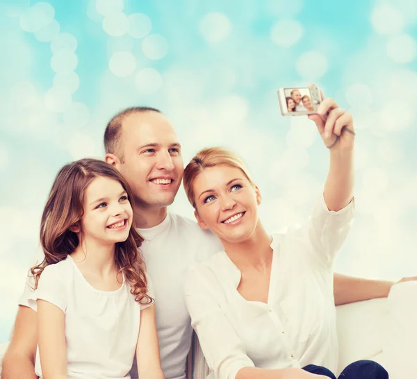 Happy family with camera at home — Stock Photo, Image