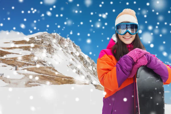 Happy young woman with snowboard over mountains — Stock Photo, Image