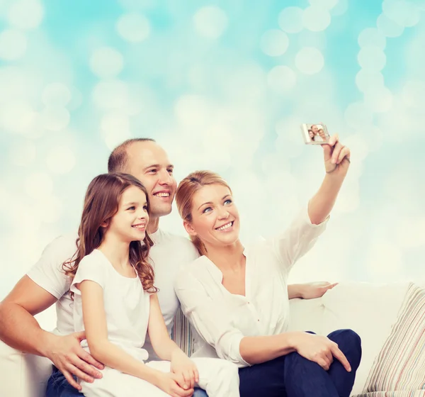 Happy family with camera at home — Stock Photo, Image