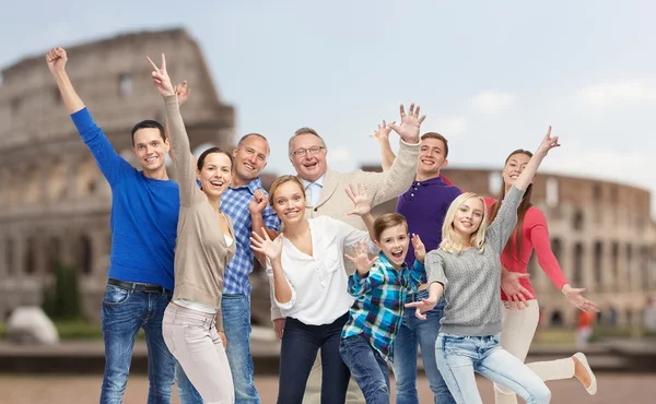 Group of happy people having fun over coliseum — Zdjęcie stockowe